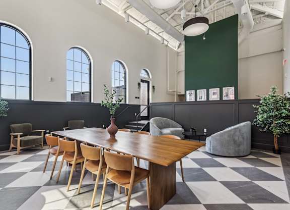 A long wooden table is surrounded by chairs in a room with a checkered floor. at LiveWell Apartments, Pennsylvania, 15222