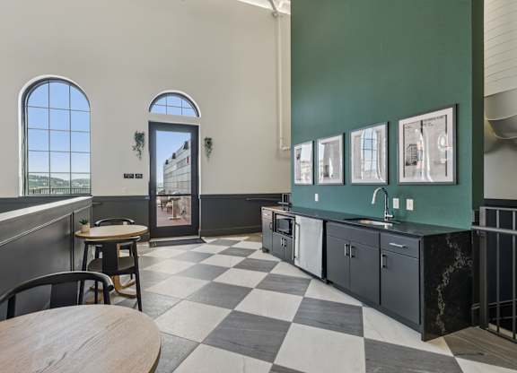 A black and white checkered floor in a room with green walls. at LiveWell Apartments, Pittsburgh 15222