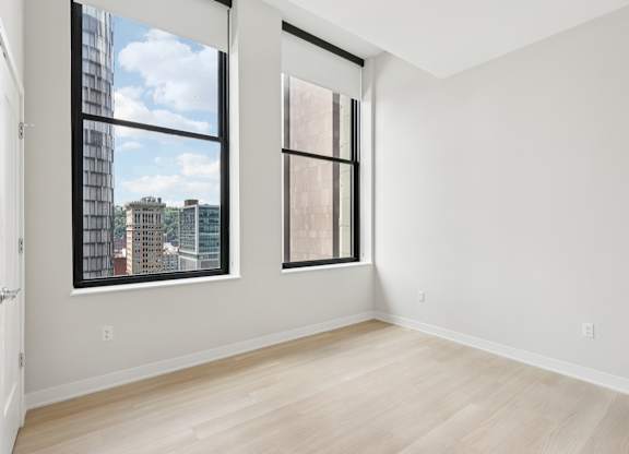 A room with a large window and a door at LiveWell Apartments, Pennsylvania
