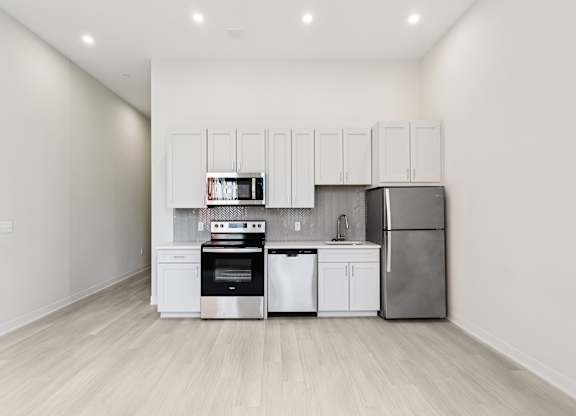 A kitchen with white cabinets and stainless steel appliances. at LiveWell Apartments, Pennsylvania