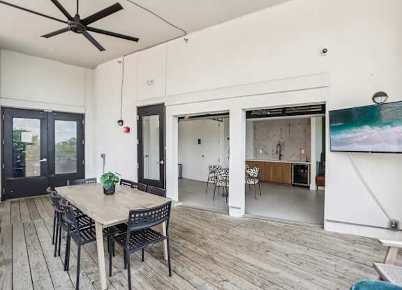 A dining room with a wooden table and chairs.