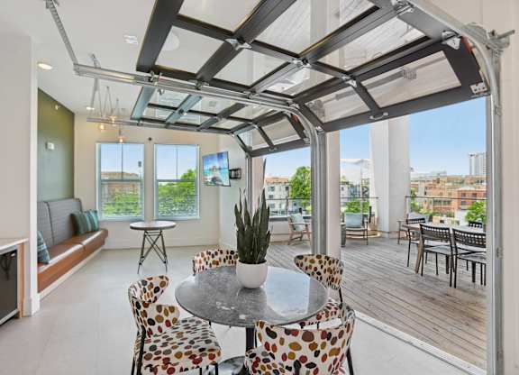 A modern dining room with a glass table and chairs.
