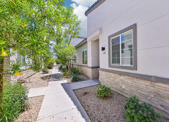 Baseline on 16th townhome with a grey roof and a small garden in front.
