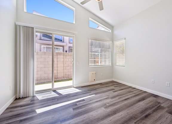 Baseline on 16th townhome living room with a sliding glass door leading to a patio.