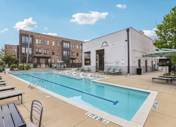 A pool area with a building in the background.