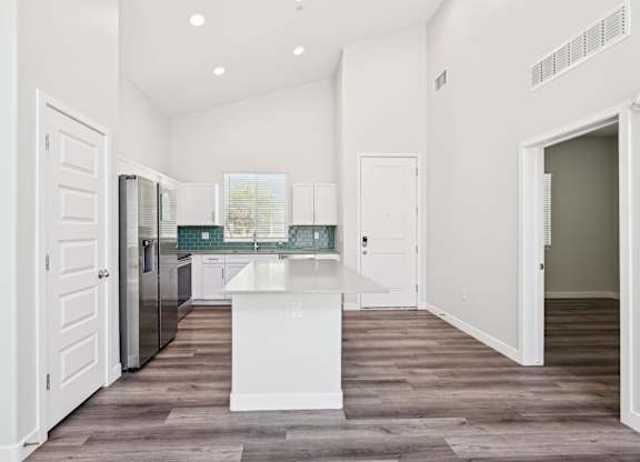 Baseline on 16th townhome kitchen with white cabinets and a white island.
