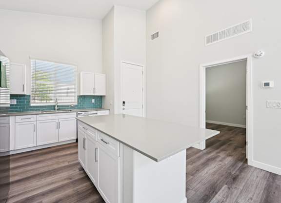 Baseline on 16th townhome kitchen with white cabinets and a white countertop.