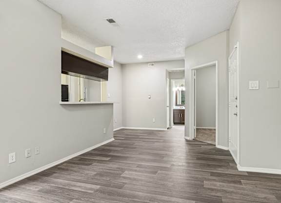 A room with a wooden floor and white walls.