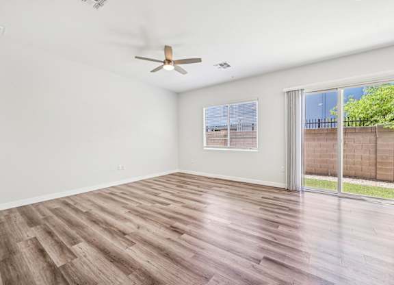 Baseline on 16th townhome bedroom with a ceiling fan and a window overlooking a fence.