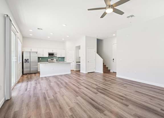 Baseline on 16th townhome spacious kitchen with a refrigerator, microwave, and oven.