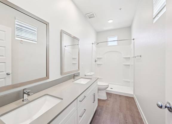 A bathroom with a sink, mirror, and toilet.