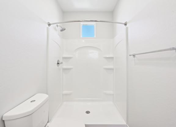 Baseline on 16th townhome bathroom with a toilet, a shower, and a bathtub.