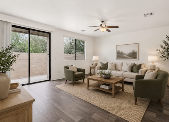 A living room with a grey couch, a wooden coffee table, and a ceiling fan.