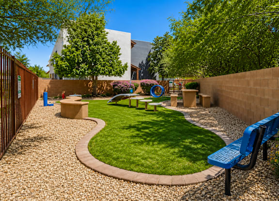 A small garden with a bench and a playground.