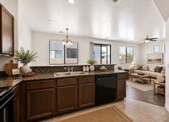 A modern kitchen with dark wood cabinets and a black dishwasher.