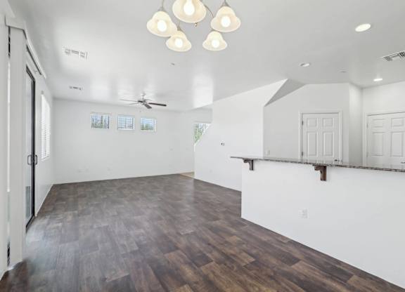 A room with wooden floors and white walls.