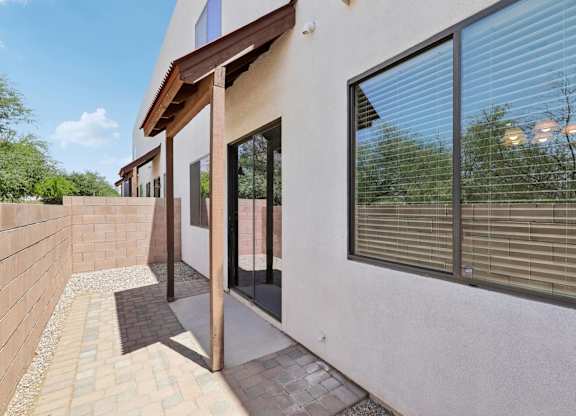 A modern house with a white exterior and a glass door.