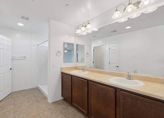 A bathroom with a vanity and a large mirror.