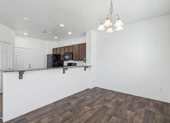 A room with a wooden floor and a white wall.