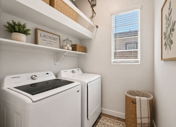 A small laundry room with a washer and dryer.