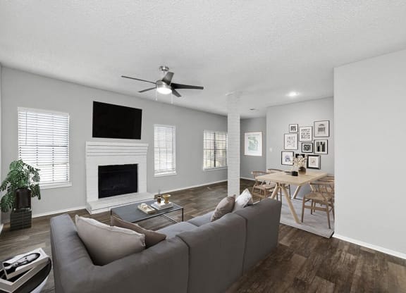 a living room with a couch and a ceiling fan at Heatherstone, Dallas, TX, 75287