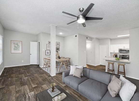 a living room with a couch and a ceiling fan at Heatherstone, Texas