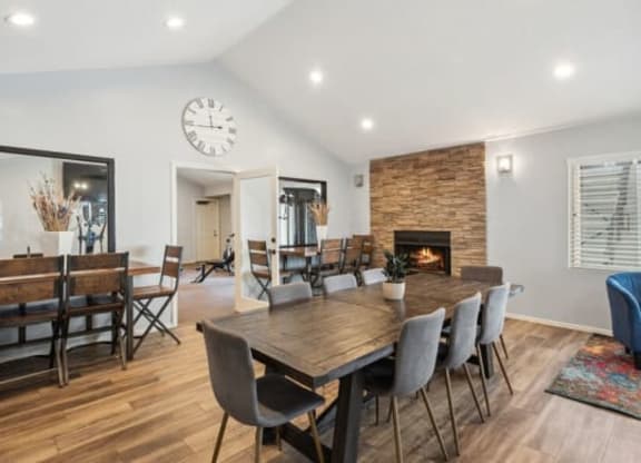 a dining room with a wooden table and chairs and a fireplace at Bella Vista, St. George, Utah