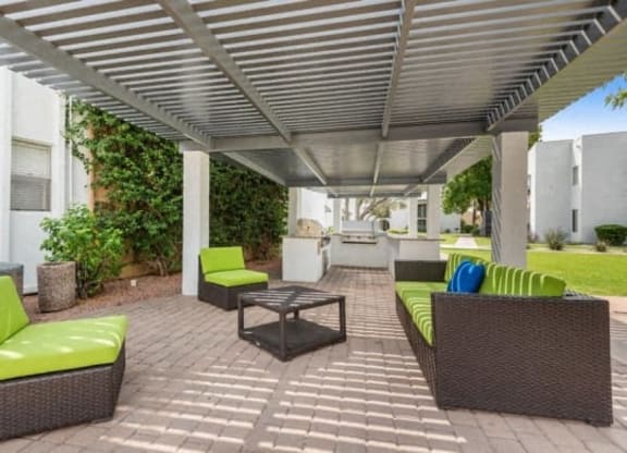 a patio with couches and a table under a roof at Vertu, Arizona