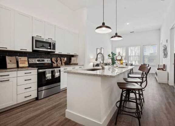 a white kitchen with a counter top and a sink at Smith and Porter, Georgia