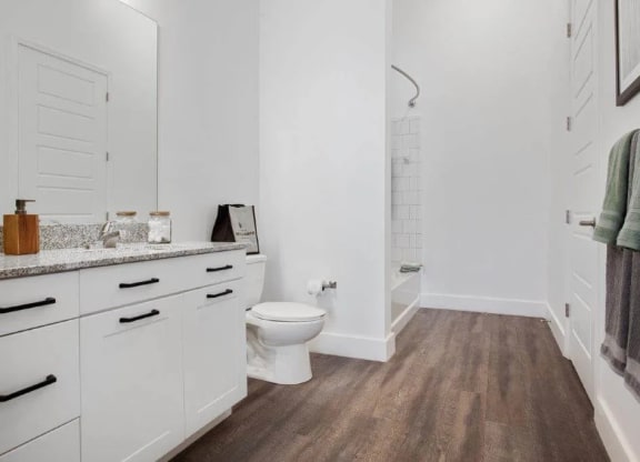 a white bathroom with a toilet and a shower at Smith and Porter, Atlanta, 30313