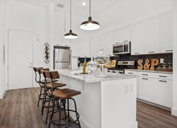 a kitchen with white cabinets and a counter top at Smith and Porter, Atlanta