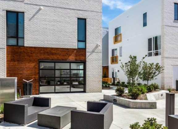A modern building with a brick facade and a glass door.