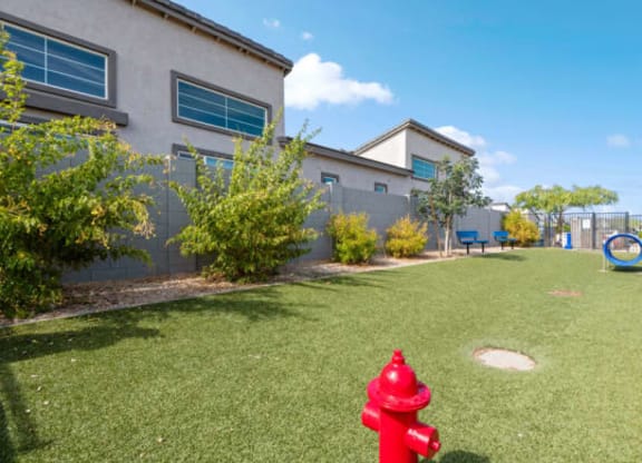 a red fire hydrant in the grass in front of a houseat Baseline on 16, Arizona
