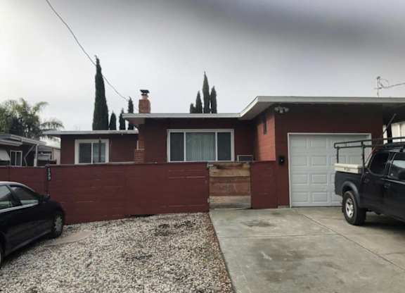 the front of a house with a driveway and a garage door