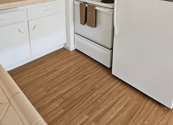 a kitchen with white appliances and white cabinets