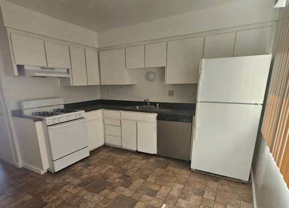 a small kitchen with a stove and a refrigerator