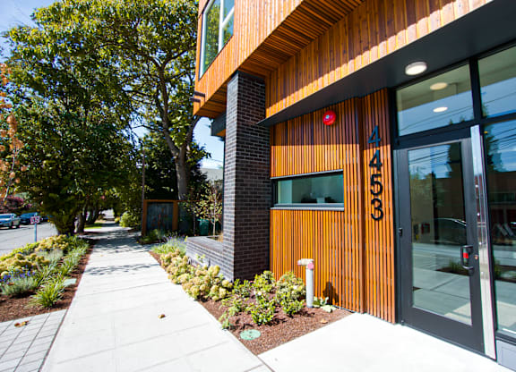 A modern building with a glass door and a number 426 on it.