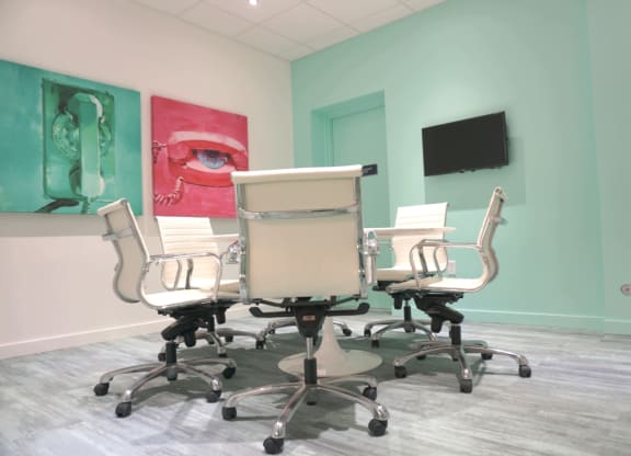 a conference room with a table and chairs