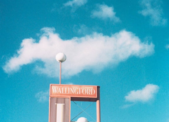 a sign for a inn on the side of a street