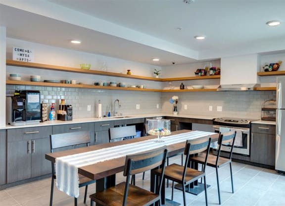 a large kitchen with a long table and chairs