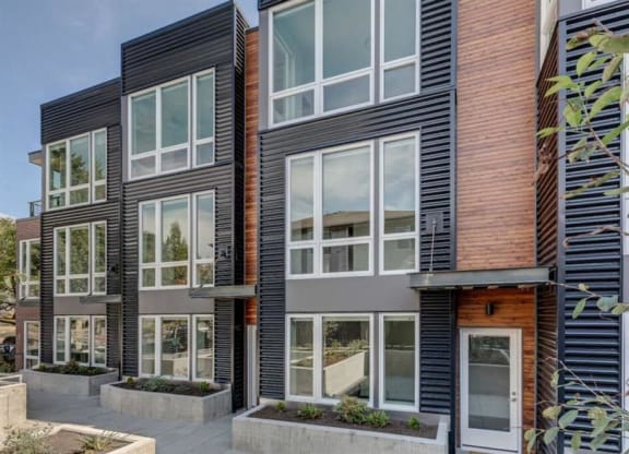 the exterior of a condo building with large glass windows