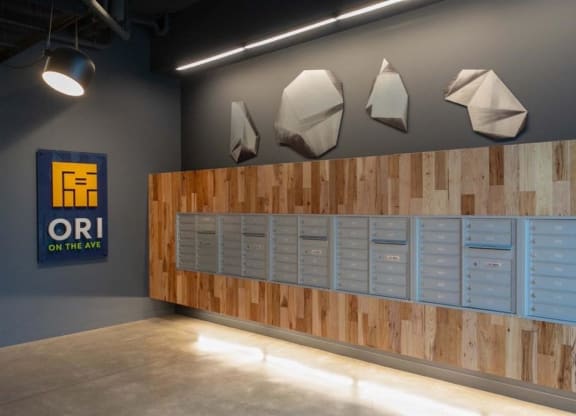 a row of blue lockers in a room with a wall of wood