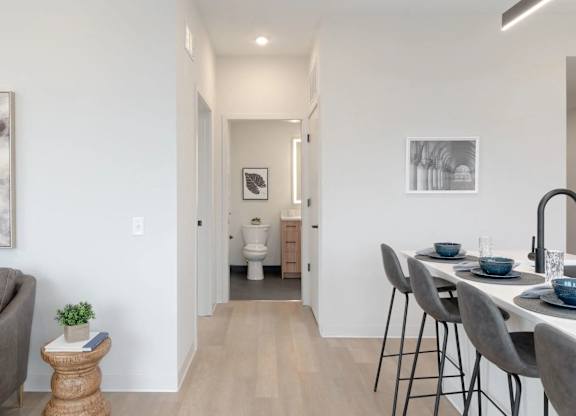 A modern dining area with a table set for two.
