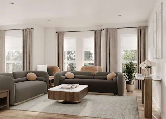 A modern living room with grey sofas and wooden coffee tables.
