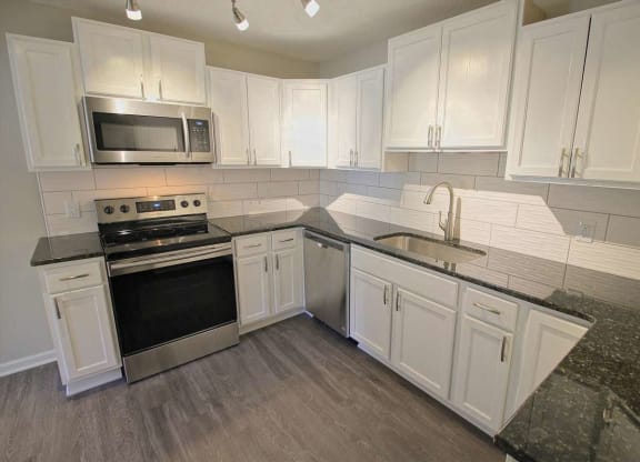 a kitchen with white cabinets at Viceroy Apartments, North Carolina, 27707