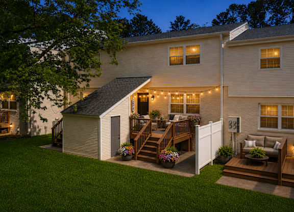 A house with a deck and a small shed.