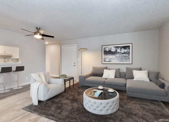 an open living room with a couch and a chair  at Eastwood Crossings, Kansas City, MO, 64129