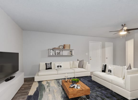 a living room with two white couches and a coffee table  at Eastwood Crossings, Missouri