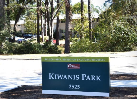 a sign for kiwis park in front of trees at Parkside at Five Points Apartments, Raleigh , North Carolina