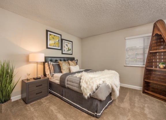 a bedroom with a bed and a window at Lodge of Overland Park Apartments, Overland Park , Kansas